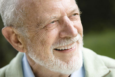 older man with dental bridge smiles
