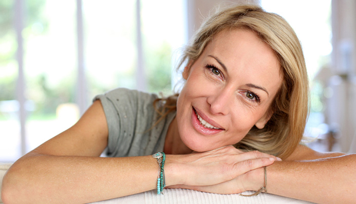 blonde woman wearing torquoise bracelets smiles