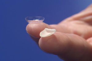 dental veneer balanced on fingers