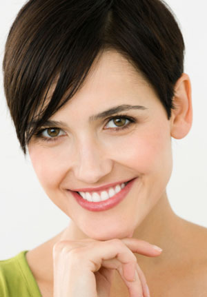 woman with short brown hair smiles