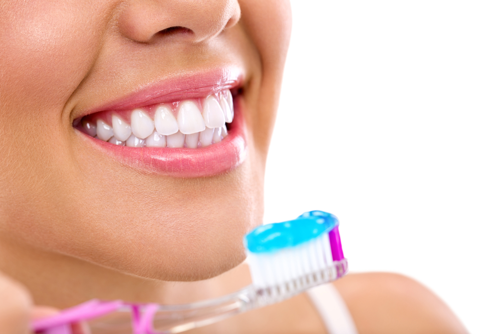 close up of a woman about to brush teeth