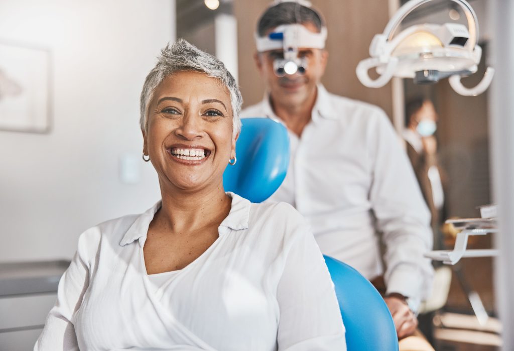 Smiling patient in dental chair with dentist