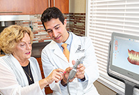 Intra-oral scanning wand taking a digital impression