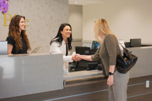 woman paying at dental office