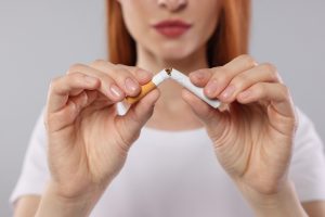 woman breaks cigarette in half